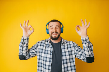 Happy caucasian guy shows a good gesture, agrees with something, claims that everything is fine,...