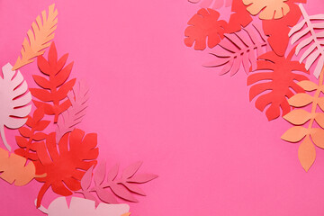 Frame made of different paper tropical leaves on pink background
