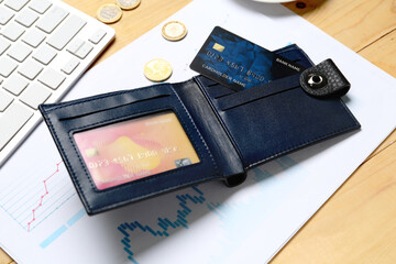 Wallet with credit card and keyboard on wooden table