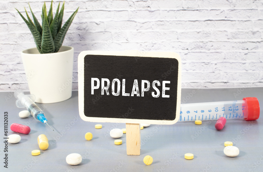 Poster prolapse text on notepad on a light table next to hand vrcha with tablets and stethoscope on the tab