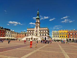 Obraz premium tourists visitors main market square in the Old Town. Town Hall in Zamosc. Poland