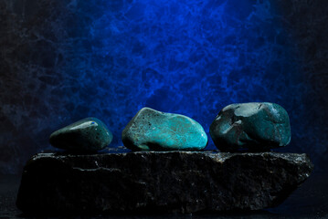 zen stones for the podium on a blue background.oval stones on a dark blue background for the presentation of the product background of the podium.composition of stones for the background with free spa