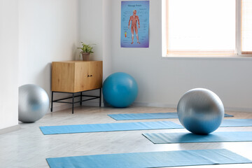 Interior of rehabilitation center with fitballs and mats