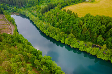 Fototapeta na wymiar Aerial view of green summer forest and blue river