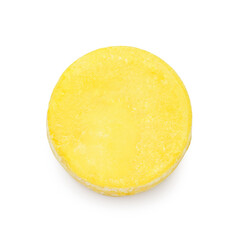 Yellow solid shampoo bar on white background