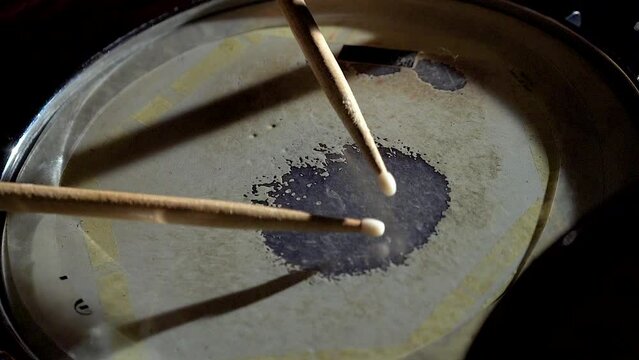 Unrecognizable musician man drummer is playing hitting drum on drums kit.