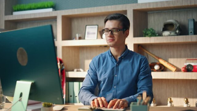 Smiling creator working computer office closeup. Inspired man checking notebook