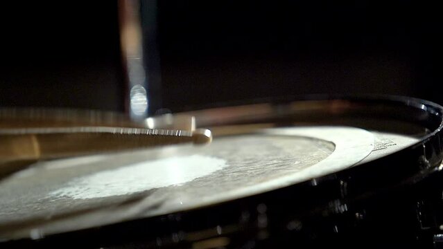 Unrecognizable musician man drummer is playing hitting drum on drums kit.