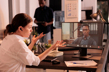 Employee discussing analytics report with project manager on corporate online meeting, coworkers talking on teleconference using videocall application. Company birefing, telecommuting