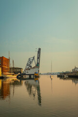 Fototapeta premium Mystic River Bascule Bridge rising up while yachts and boats wait to pass, summer coastal landscape in Connecticut