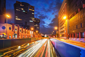 Lisbon cityscape at dusk - street traffic with long exposure motion blurred car lights trails in Amoreiras, Lisbon, Portugal