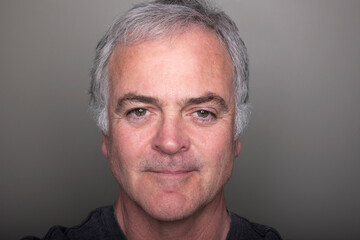 Studio portrait of smiling mature man.