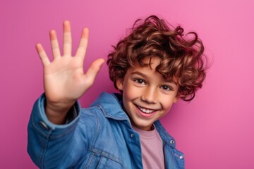 Close-up portrait photography of a joyful boy in his 30s making a no or stop gesture with the extended palm against a hot pink background. With generative AI technology