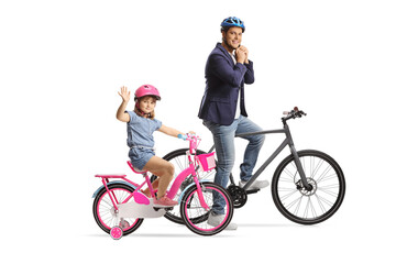 Girl and a man on bicycles wearing helmets