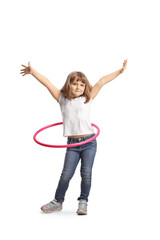 Full length portrait of a little girl spinning a hula hoop and smiling