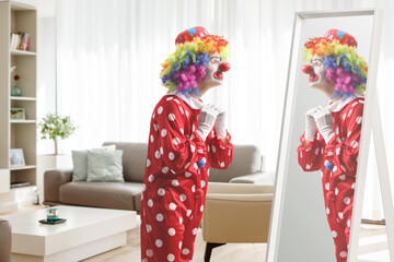 Clown standing in front of a mirror at home