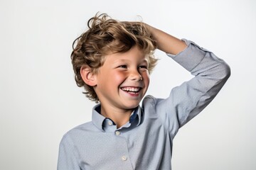 Lifestyle portrait photography of a happy kid male scratching one's head in a gesture of confusion against a pearl white background. With generative AI technology