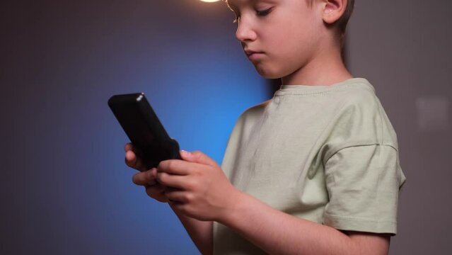 close-up of a boy playing tetris an old retro console game 