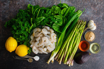 Naklejka na ściany i meble Shrimp, Asparagus, and Avocado Salad and Lemon Vinaigrette Ingredients: Ingredients for a healthy green salad with shrimp and lemony salad dressing
