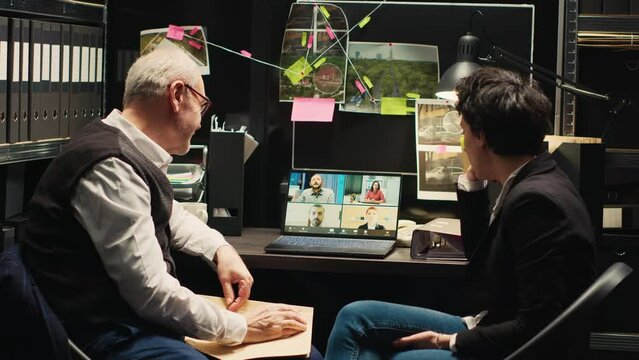 Detectives attending videocall meeting with team of forensic experts to discuss about incriminating proof and clues. Police officers on online telework call review case evidence.