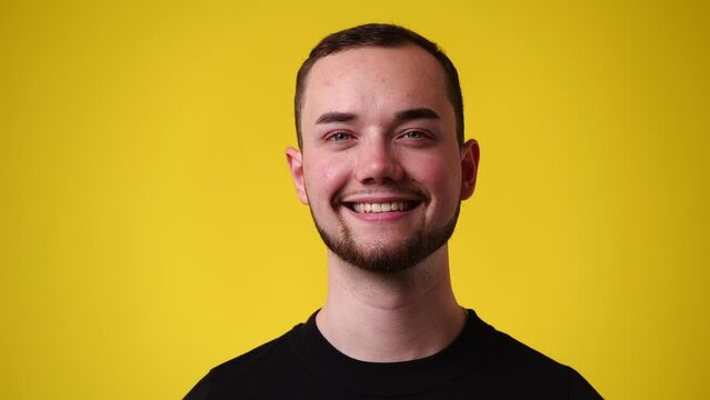 4k video of one man who posing and smiling over yellow background.