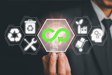 Circular economy concept, Businessman hand holding Light bulb with circular economy icon on virtual...