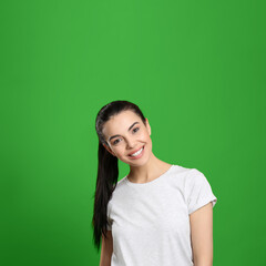 Fototapeta premium Chroma key compositing. Pretty young woman with dark hair against green screen