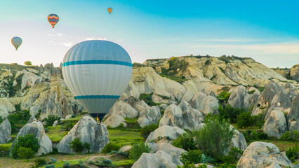Cappadocia Turkey. Hot air balloons flying over fairy chimneys at sunrise in Cappadocia. Travel to...