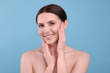 Beautiful woman with healthy skin on light blue background. Body Care