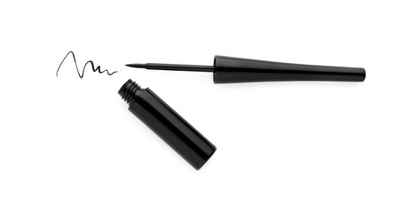 Black eyeliner and stroke on white background, top view. Makeup product