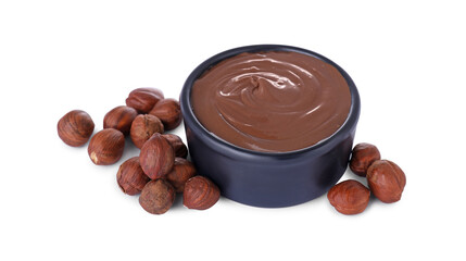 Bowl with delicious chocolate paste and hazelnuts on white background