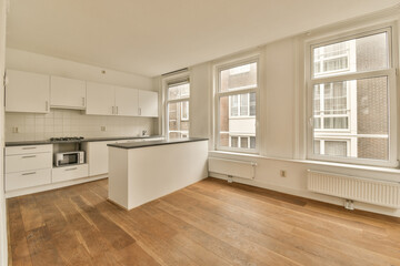 an empty kitchen with wood flooring and white cabinets in the room is very clean, but it's no longer