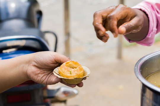Phuchka or Pani Puri being served on a bowl made of shal leaves in india. This popular street food is also called gupchup or golgappa. It is crunchy fried hollow balls made of wheat.