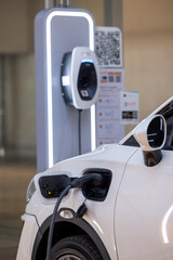 EV charging an electric car. Power supply for electric car charging. Socket for electrical car...