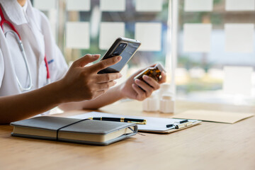 Fototapeta premium Female doctor with laptop working at table Portrait of Asian female doctor working with patient papers in her office at clinic close up photo