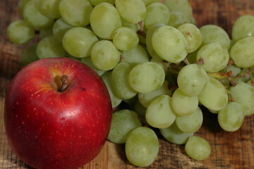 Fresh red apple with grapes on white background. With clipping path