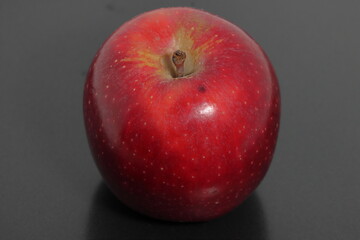 red apple on black background