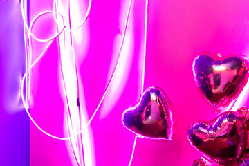 pink inflatable metallic balloons illuminated with neon light