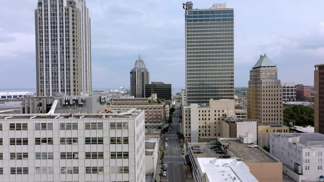 Close up view of downtown Mobile, Alabama with drone video moving up.