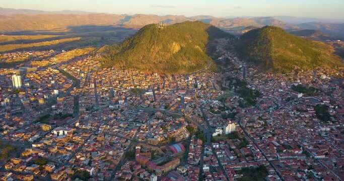 Aerial view over the picturesque, historic city of Sucre, Bolivia during the evening's golden hour.