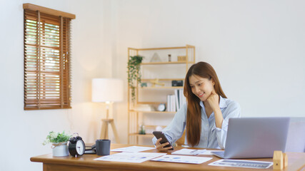 Home office concept, Businesswoman reading data on smartphone to analysis marketing plan of startup