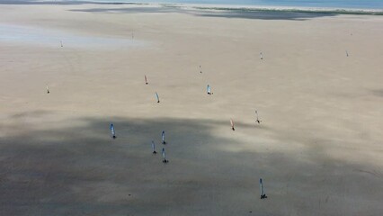 Drone shot people land sailing or sand yachting with blokarts on beach