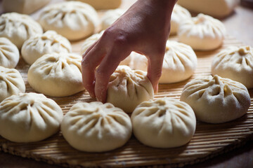 Homemade people making raw steamed buns. Delicious baozi,