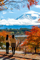 Happy Asian woman friends travel Japan together on autumn holiday vacation. Attractive girl enjoy...