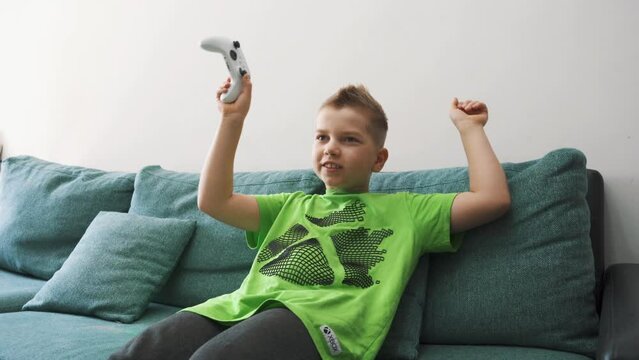 Kid Plays Console. Baby Boy Presses Joystick. Domestic Life and Leisure Activity. Computer and Video Game. Boy Hands on a Controller Playing Video Games. Child Boy Playing Console Game on at Home