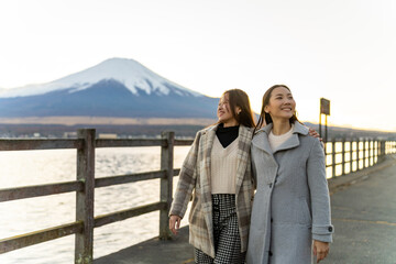 Happy Asian woman travel Japan on autumn holiday vacation. Attractive girl friends enjoy and fun...