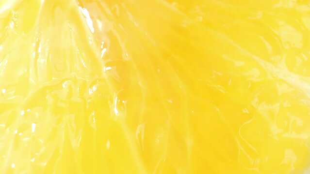 Through a macro lens, the inner world of a lemon unfolds, unveiling a captivating landscape of delicate, juice-filled sacs and a refreshing burst of citrus fragrance. Fruit and vegetable concept. 4K
