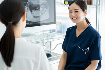Obstetrician explaining ultrasound pictures to a patient