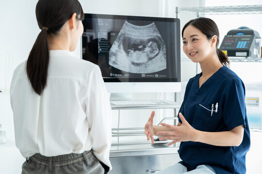 Obstetrician explaining ultrasound pictures to a patient