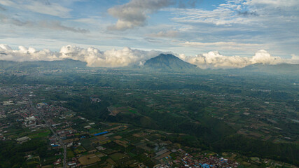 Farmland in the countryside and mountains early in the morning. Agricultural landscape. Berastagi, Sumatra. Indonesia.